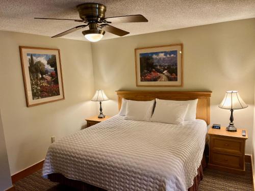 a bedroom with a bed with two night stands and two lamps at MT CB Base Area with King Bed, Outdoor Hot Tub & Pool in Crested Butte