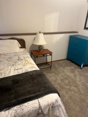 a bedroom with a bed and a table with a lamp at Anthony's Home in Spokane