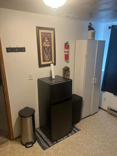 a room with a refrigerator and a table with a candle at Anthony's Home in Spokane