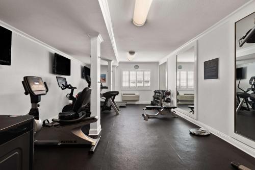 a gym with treadmills and exercise equipment in a room at City Express by Marriott Manhattan Beach in Manhattan Beach