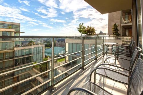 a balcony with chairs and a table on a building at Waterfalls Hotel in Downtown With Stunning Views! in Victoria