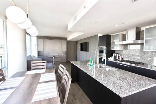 a kitchen with a large island in a room at Waterfalls Hotel in Downtown With Stunning Views! in Victoria