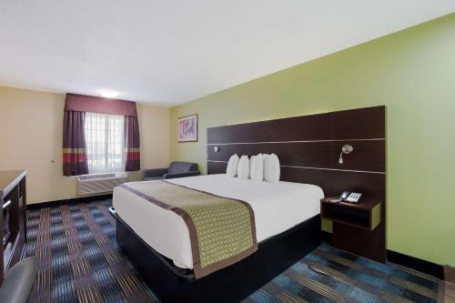 a hotel room with a large bed and a window at SureStay Hotel by Best Western Manning in Manning