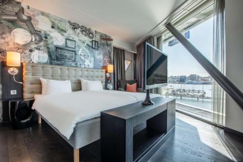 a bedroom with a large bed and a large window at Radisson Blu Riverside Hotel in Gothenburg