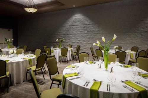 a banquet room with tables and chairs with white table linens at Macon Marriott City Center in Macon