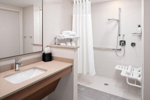 a bathroom with a sink and a shower at Fairfield by Marriott Inn & Suites Whitsett Greensboro East in Whitsett