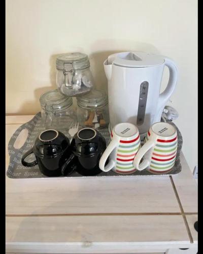 a tray with cups and bowls and a blender at The dublin packet family room in Holyhead