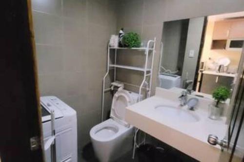 a bathroom with a sink and a toilet and a sink at 1 BR Condo in East BelAir Residence Cainta Rizal with parking in Manila