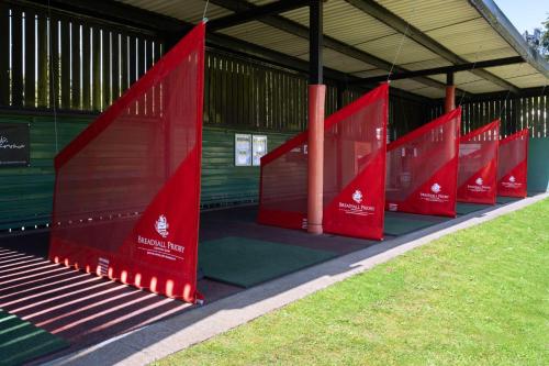 a row of red dividers in a building at Delta Hotels by Marriott Breadsall Priory Country Club in Derby