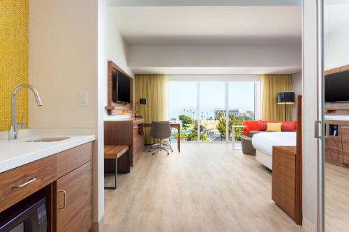 a hotel room with a bed and a living room at Courtyard by Marriott Santa Monica in Los Angeles