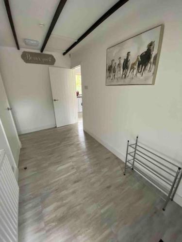 a room with a painting of horses on the wall at Beautiful renovated former coach house in Llandeilo