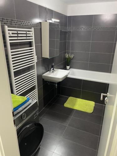 a bathroom with a sink and a toilet at Moderní byt v Brně u BRuNA in Slatina