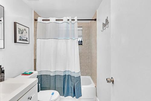 a bathroom with a shower curtain and a toilet at Beach And Hard Rock Hollywood Vacation House Ha02 in Hollywood