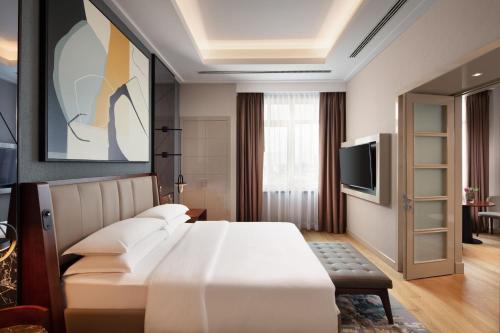 a hotel room with a bed and a tv at Sheraton Istanbul Levent in Istanbul