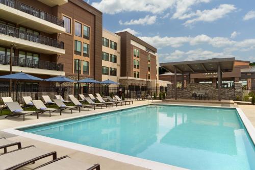 a swimming pool with lounge chairs and a building at SpringHill Suites by Marriott Franklin Mint in Franklin