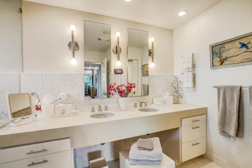 a bathroom with two sinks and a large mirror at The Novel Retreat in Austin