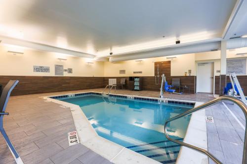 a large swimming pool in a building at Fairfield Inn & Suites Marquette in Marquette