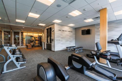 a gym with cardio equipment in a hotel room at Fairfield Inn & Suites Marquette in Marquette