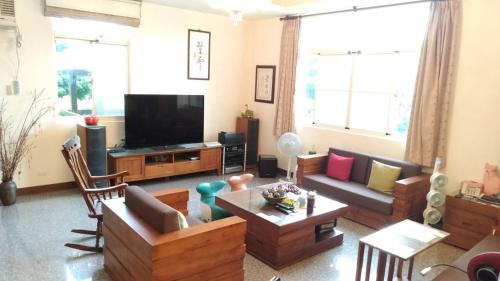 ein Wohnzimmer mit Möbeln und einem Flachbild-TV in der Unterkunft 登雲villa in Shan-lin