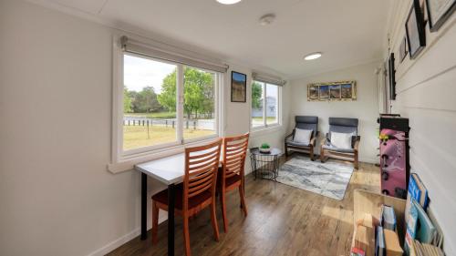 a dining room with a table and chairs and a window at Creekview Cottage - 70 Lock Street in Stanthorpe