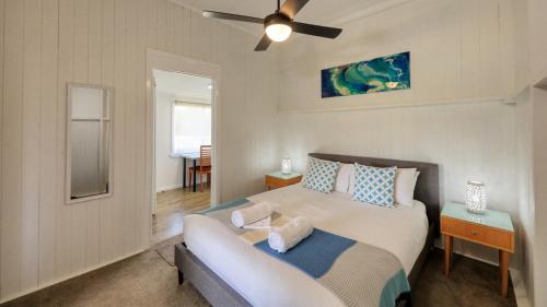 a bedroom with a bed and a ceiling fan at Creekview Cottage - 70 Lock Street in Stanthorpe