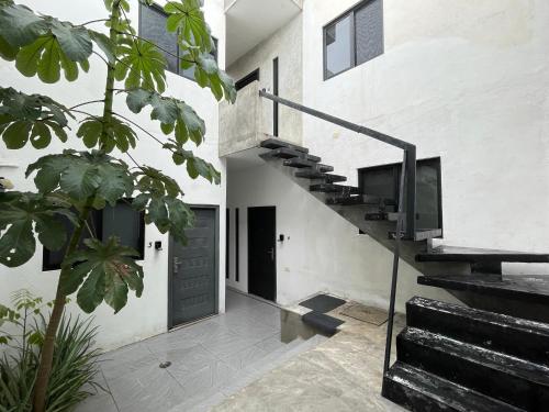 a staircase in a house with a black door at Casa y departamentos lavanda in Mérida