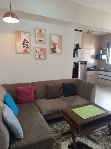 a living room with a couch and a table at Cozy Home near Bhavali Dam in Igatpuri