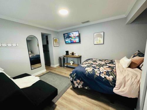 a bedroom with a bed and a tv on the wall at Coral Gables Miami Studio near Airport and Beaches in Miami