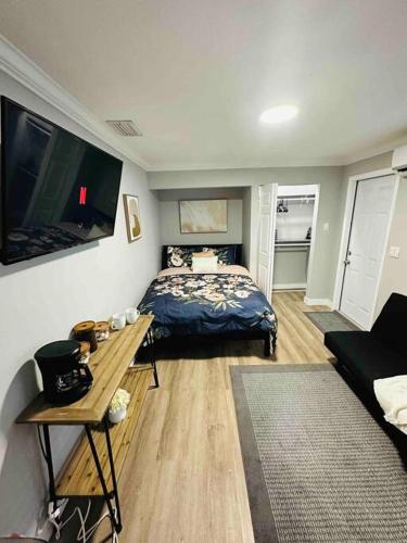 a bedroom with a bed and a table and a couch at Coral Gables Miami Studio near Airport and Beaches in Miami