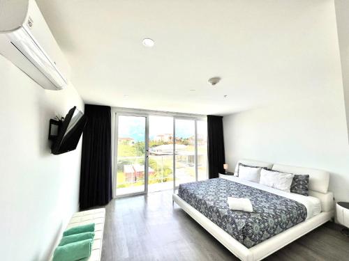 a bedroom with a bed and a large window at Las Islas #12 in Palm-Eagle Beach