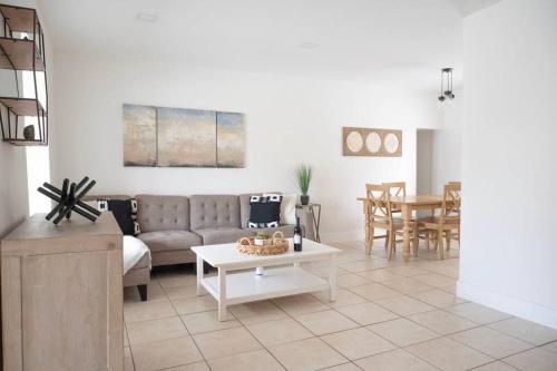 a living room with a couch and a table at Coral Gables Home with POOL Near Airport. King beds in Miami