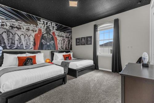 een slaapkamer met 2 bedden en een muur met een Star Wars muurschildering bij 4 Bedrooms - 3,5 Bathrooms - Solara 9032 Em in Kissimmee