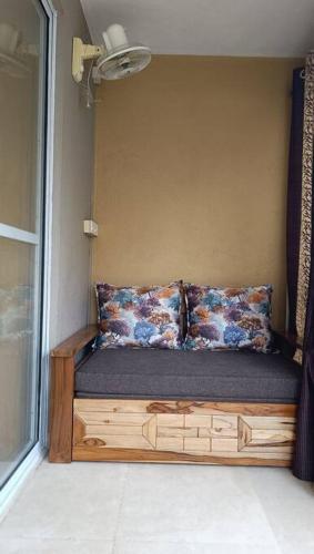 a small bed in a room with a window at Cozy Studio near Bhavali Dam in Igatpuri