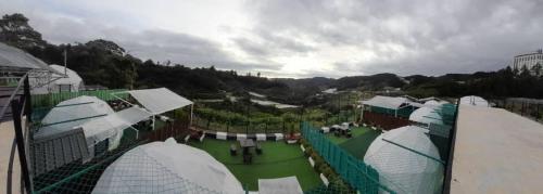 an aerial view of a golf course with buildings at Glamz Hills in Cameron Highlands