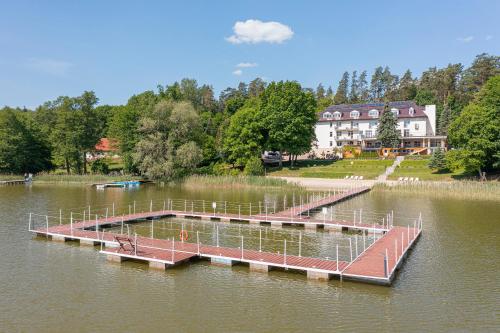 a dock in the middle of a lake at Ośrodek Gawra in Nidzica