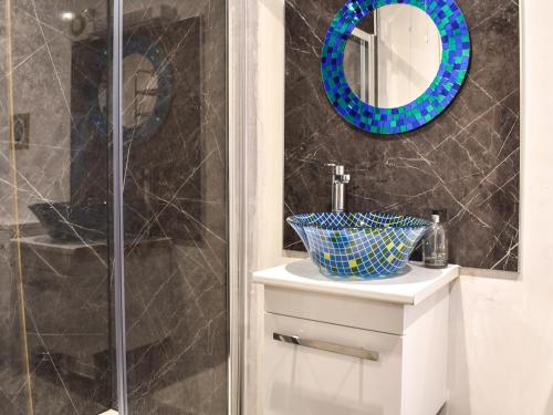 a bathroom with a shower and a sink and a mirror at Shiralee in Middle Winterslow