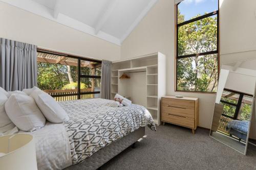a bedroom with a bed and a window at River Retreat, spa, pets, Wi-Fi in Turangi