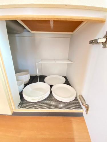 two white toilets sitting in a small bathroom at Rose Garden in Asahikawa