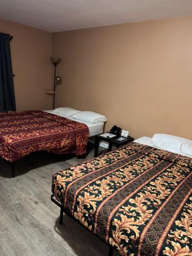 a hotel room with two beds in a room at Relax Inn in Streator