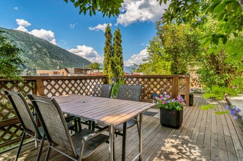 a wooden deck with a wooden table and chairs at Cloudside Hotel in Nelson