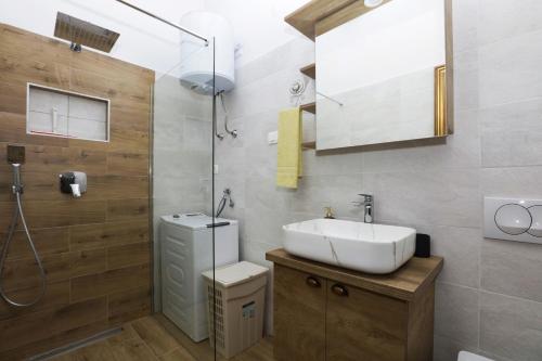 a bathroom with a sink and a shower at Apartments by the sea Jezera, Murter - 19056 in Jezera