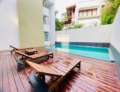 a patio with a table and a swimming pool at Hotel Kandyan View ''Free pickup from Kandy city'' in Kandy