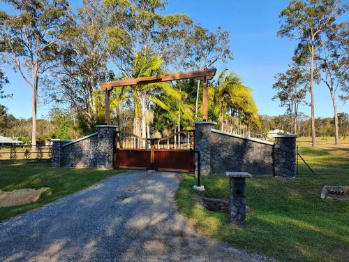 a gate in a field with a fence at Luxurious Countryside Retreat - Visit our private apartment on our acreage property! in Park Ridge