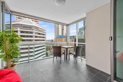 a balcony with a table and chairs on a balcony at Heart of the CBD ~ 1Bed/1Bath/Balcony/Free Parking in Brisbane