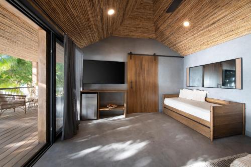 a bedroom with a bed and a flat screen tv at Arca in West Bay