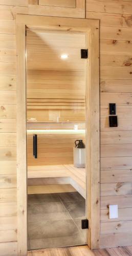a sauna with wood paneling and a wooden wall at Tremblant chalet O-Spa in Lac-Superieur