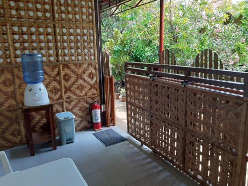 an outside area of a house with a fence at Alimpay Foresters Apartment in Panglao