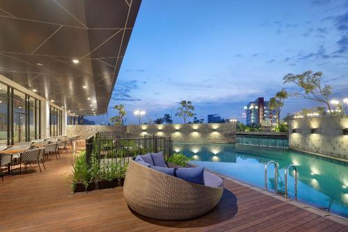 a resort with a swimming pool at night at THE 1O1 Jakarta Airport CBC in Tangerang