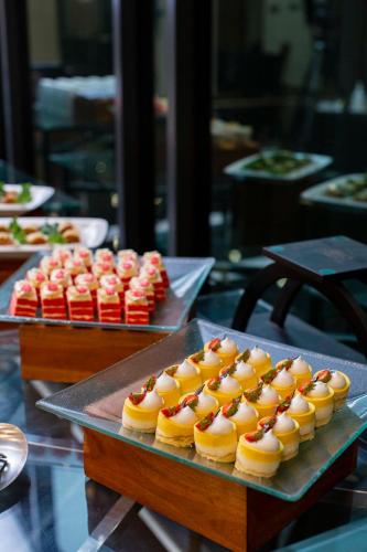 a tray of pastries sitting on top of a table at THE 1O1 Jakarta Airport CBC in Tangerang