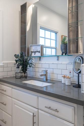 a kitchen counter with a sink and a mirror at Angel&Rose Universal Hollywood Heated Pool House King Bed in Los Angeles